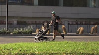 a man jogging with a baby stroller