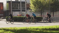 a group of people riding bicycles down a street