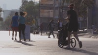 a group of people walking down a city street