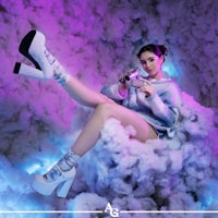 a woman is sitting on a cloud with a camera